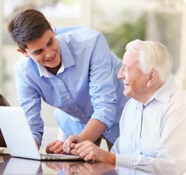 Man_helping_an_older_man_with_technology - flip